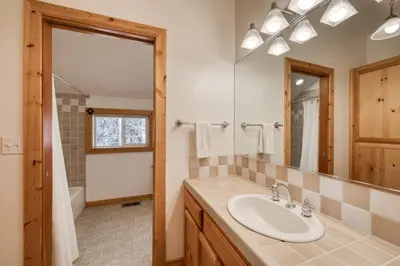 a bathroom with a sink and a mirror at Sparrow's Rest by Tahoe Getaways - Pet-Friendly 3BR in Tahoe Donner w HOA in Truckee