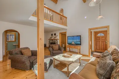 a living room with a couch and a table at Sparrow's Rest by Tahoe Getaways - Pet-Friendly 3BR in Tahoe Donner w HOA in Truckee