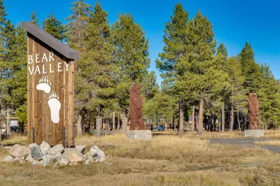 a sign for a bear valley with trees in the background at Ski-InandSki-Out Retreat with Sauna in Bear Valley! in Bear Valley