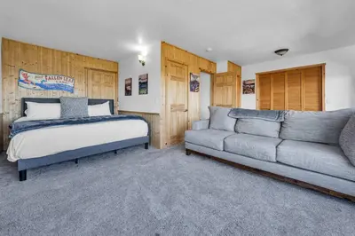 a bedroom with a bed and a couch at Wooded Hilltop Stay Shared Hot Tub + Lake Views in Stateline