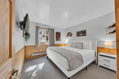 a bedroom with a large bed and a window at Wooded Hilltop Stay Shared Hot Tub + Lake Views in Stateline