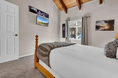a bedroom with a bed and a window at Wooded Hilltop Stay Shared Hot Tub + Lake Views in Stateline