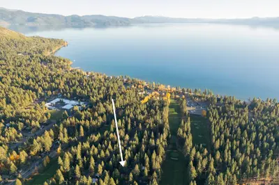 an aerial view of a forest of trees next to a lake at Diana's Cabin by Tahoe Getaways - Pet-Friendly 2BR in Kings Beach w Backyard & Walk to Lake! in Tahoe Vista