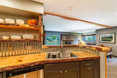 a kitchen with a sink and a counter at Tranquil & Woodsy 2/2 Retreat – Jacuzzi, W/D, BBQ! in Mammoth Lakes