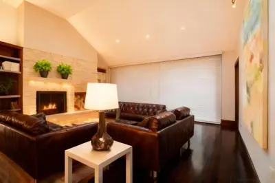 a living room with leather couches and a fireplace at Mammoth Lakes Alpine Stay in Mammoth Lakes