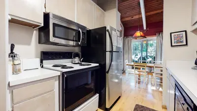 a kitchen with a stove and a refrigerator at Horizons 4 120 Great Complex Amenities, On The Shuttle Route, Walk To Shops and Restaurants condo in Mammoth Lakes