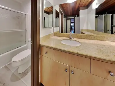 a bathroom with a sink and a toilet and a mirror at Slopeside Condo With Fireplace Snowbird 112 At 1849 Condos in Mammoth Lakes