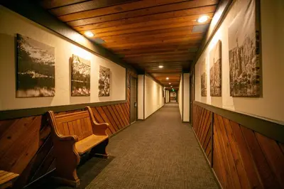 a hallway with a bench and pictures on the walls at Slopeside Condo With Fireplace Snowbird 112 At 1849 Condos in Mammoth Lakes
