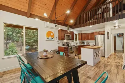 a kitchen and dining room with a wooden table and chairs at 