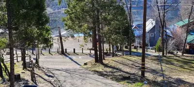 an empty street with trees on the side of a road at Lakeview Lodge, bookable boat slip! in Bass Lake