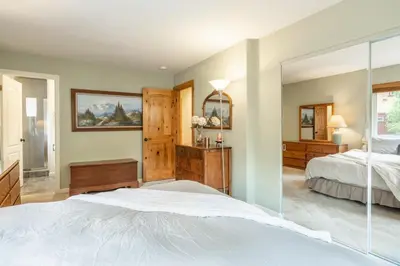 a bedroom with a bed and a mirror at North Shore - Forest Haven in Kings Beach