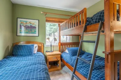 a bedroom with two bunk beds and a ladder at North Shore - Forest Haven in Kings Beach