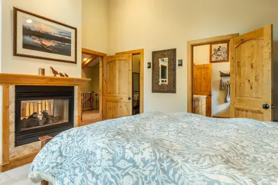 a bedroom with a bed and a fireplace at North Shore - Forest Haven in Kings Beach