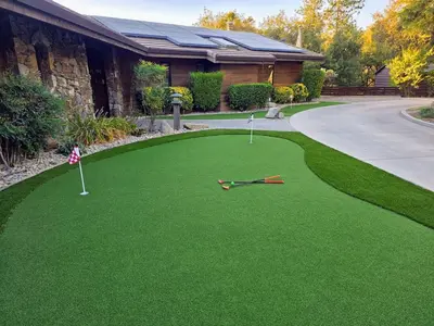 a yard of green grass with two golf clubs on it at Mountain Oasis-Indoor Hot Tub, Game Room, VIEWS in Oakhurst