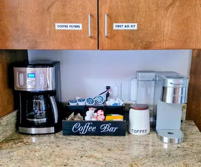 a kitchen counter with a coffee box and a coffee maker at Mountain Oasis-Indoor Hot Tub, Game Room, VIEWS in Oakhurst