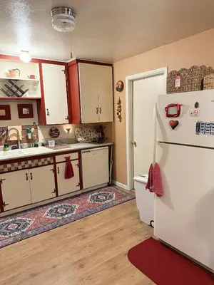 a kitchen with white cabinets and a refrigerator at CYH0822 - Pinter Pines Retreat home in South Lake Tahoe