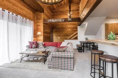 a living room with a couch and a table at Spacious 3BD & Loft Villa - Convenient to Slopes in Mammoth Lakes