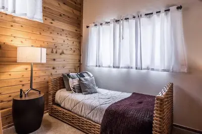 a bedroom with a bed with a lamp and a window at Spacious 3BD & Loft Villa - Convenient to Slopes in Mammoth Lakes