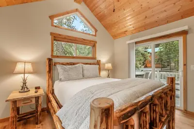 a bedroom with a bed and a window at Woodlands House home in Truckee