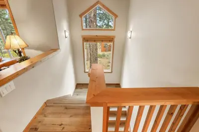 a staircase in a tiny house with a window at Woodlands House home in Truckee