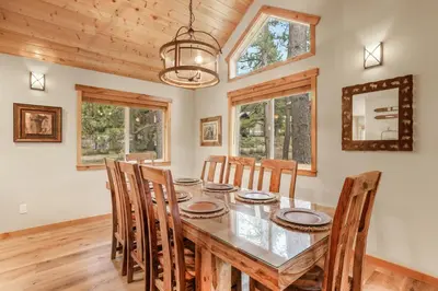 a dining room with a table and chairs at Woodlands House home in Truckee