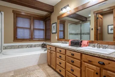 a bathroom with two sinks and a bath tub and a tubermott at Lodges 1178 - Timber Lodge Retreat in Mammoth Lakes