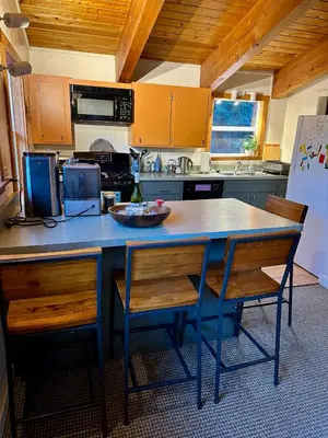 a kitchen with a blue table and two chairs at Tahoe Park HOA l Palisades l Hot Tub l Dogs OK in Tahoe City