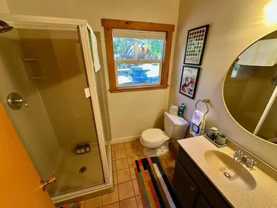 a bathroom with a shower and a toilet and a sink at Tahoe Park HOA l Palisades l Hot Tub l Dogs OK in Tahoe City