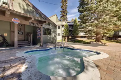 a swimming pool in front of a building at Mammoth Mtn Ski-InandOut Condo with Hot Tub Access! in Mammoth Lakes