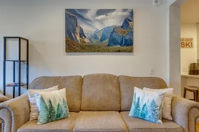 a couch in a living room with a painting on the wall at Mammoth Mtn Ski-InandOut Condo with Hot Tub Access! in Mammoth Lakes