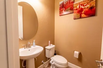 a bathroom with a sink and a toilet and a mirror at Sierra Vista Retreat - Reno Tahoe in Reno