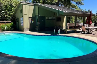 a large blue swimming pool in front of a building at Hidden Valley 114 I in Mammoth Lakes