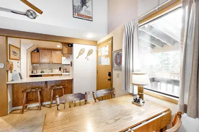 a kitchen and dining room with a wooden table and chairs at Hidden Valley 26 D in Mammoth Lakes