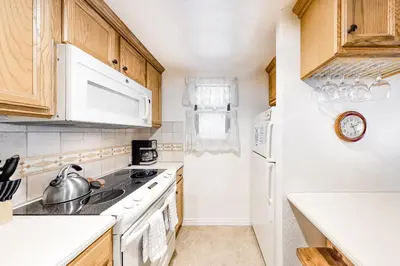 a kitchen with white appliances and wooden cabinets at Hidden Valley 26 D in Mammoth Lakes