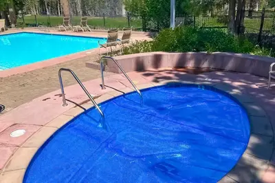 a large swimming pool with a blue pool at Mammoth Green 116 in Mammoth Lakes