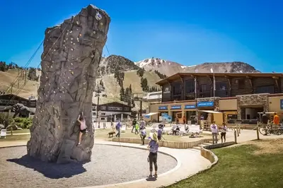 a group of people standing next to a rock wall at Mammoth Green 116 in Mammoth Lakes