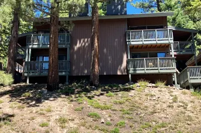 a house with balconies and trees in front of it at Hidden Valley 14 B in Mammoth Lakes