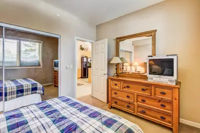 a bedroom with a bed and a tv on a dresser at Mammoth Green 219 in Mammoth Lakes