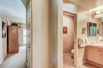 two images of a bathroom with a sink and a toilet at Mammoth Green 219 in Mammoth Lakes