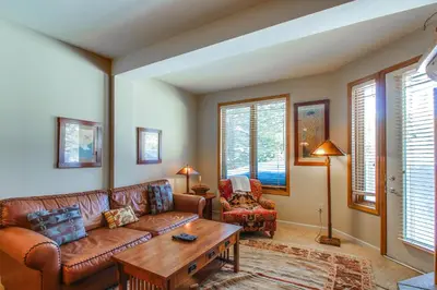 a living room with a couch and a table at Mammoth Green 110 in Mammoth Lakes