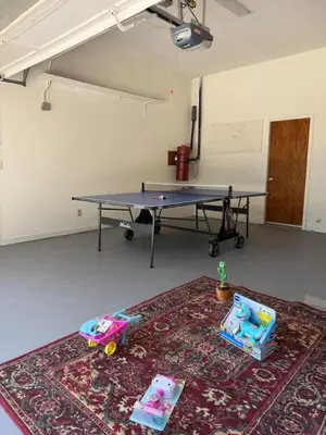 a ping pong table in a room with a rug at Newly Renovated Lakefront with Dock in Bethel Island