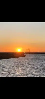 a sunset over a body of water with the sun setting at Newly Renovated Lakefront with Dock in Bethel Island