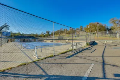 a tennis court with two tennis courts at Scenic Yosemite Lakes Escape with Community Perks! in Coarsegold