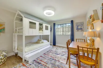 a bedroom with a bunk bed with a table and a desk at Scenic Yosemite Lakes Escape with Community Perks! in Coarsegold