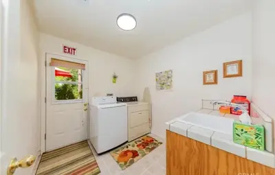 a kitchen with a sink and a white refrigerator at The Lady Bug Family Retreat in Mariposa