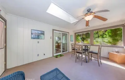 a dining room with a ceiling fan and a table and chairs at The Lady Bug Family Retreat in Mariposa