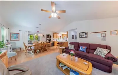 a living room with a purple couch and a table at The Lady Bug Family Retreat in Mariposa