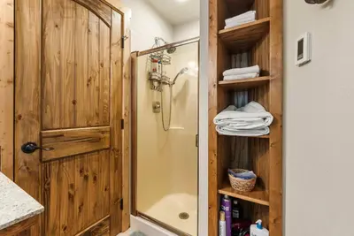 a shower with a glass door in a bathroom at Tranquil Treehouse near Fly-In Lake with Deck Dining & BBQ in Arnold