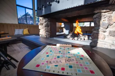 a game on a table in front of a fireplace at Outbound Mammoth in Mammoth Lakes