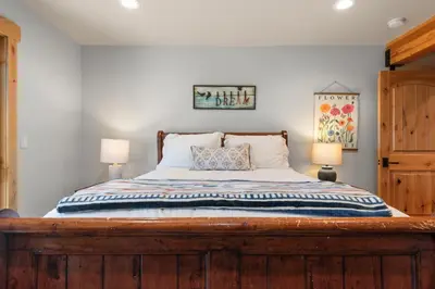 a bedroom with a wooden bed with two lamps at Bella Casa - North Lake Tahoe in Tahoe City